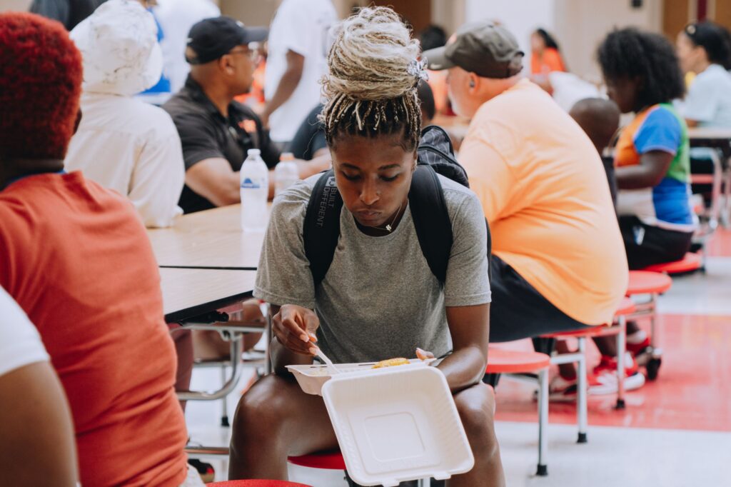 Girl enjoying a Mercy Chefs hot meal