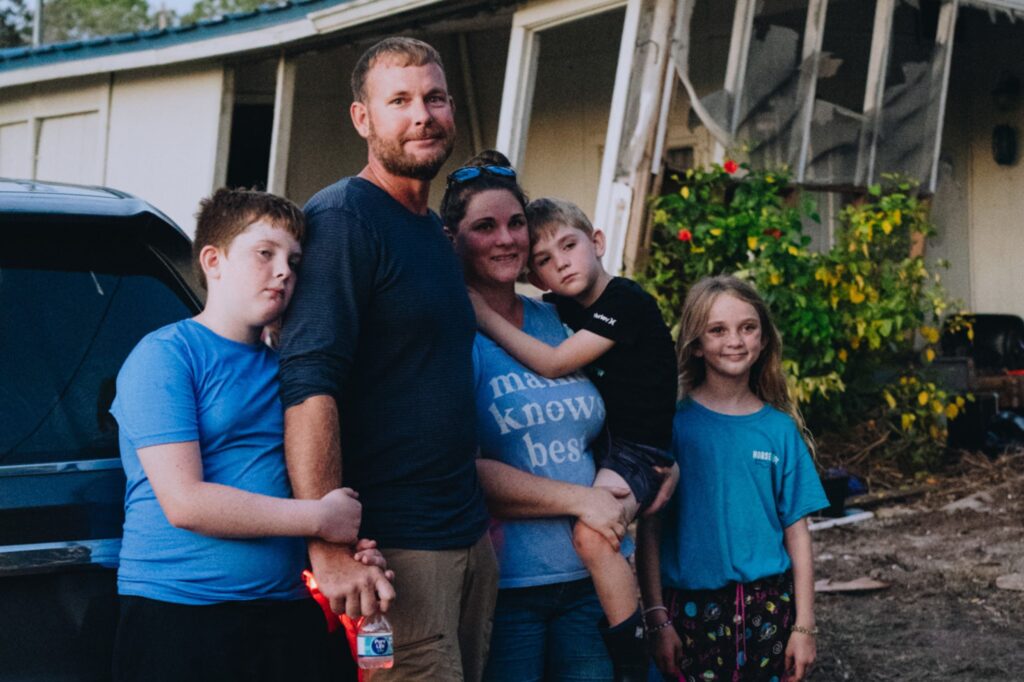 Family receiving water and hot meals in Florida after Hurricane Helene