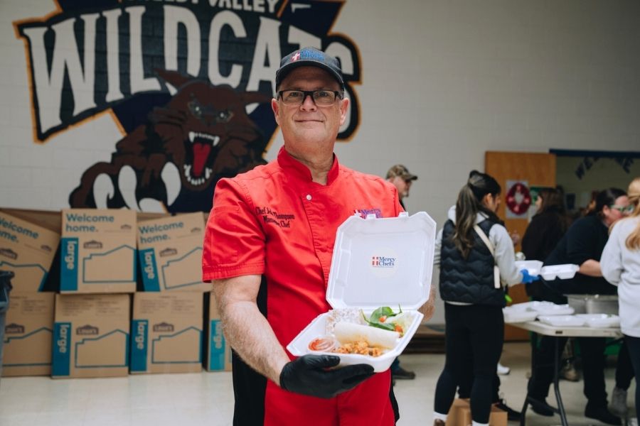 Chef John holding Mercy Chefs' first meal prepared for those impacted by the floods in Kentucky.