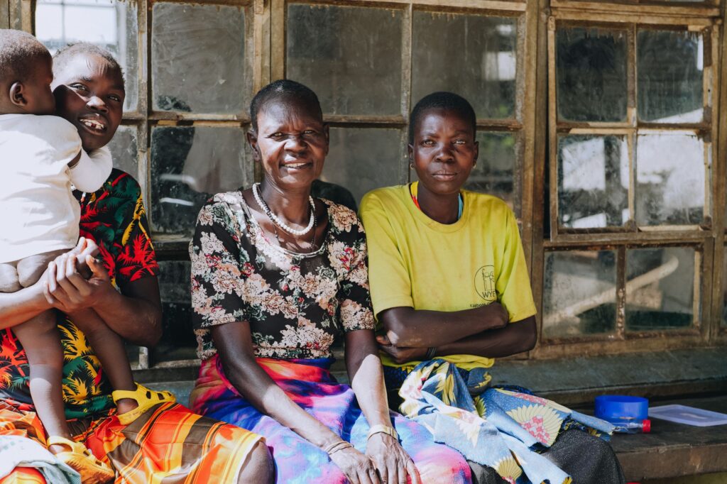 A family at a hospital in Kaabong, Uganda, smiling.