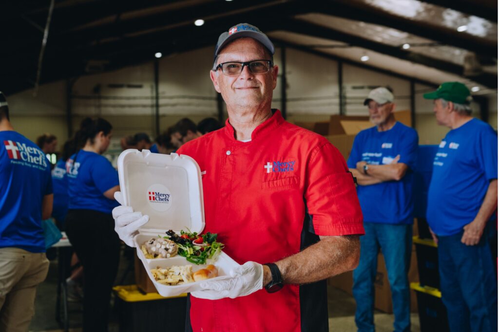 Chef John holding a Mercy Chefs meal in Selmer, TN.