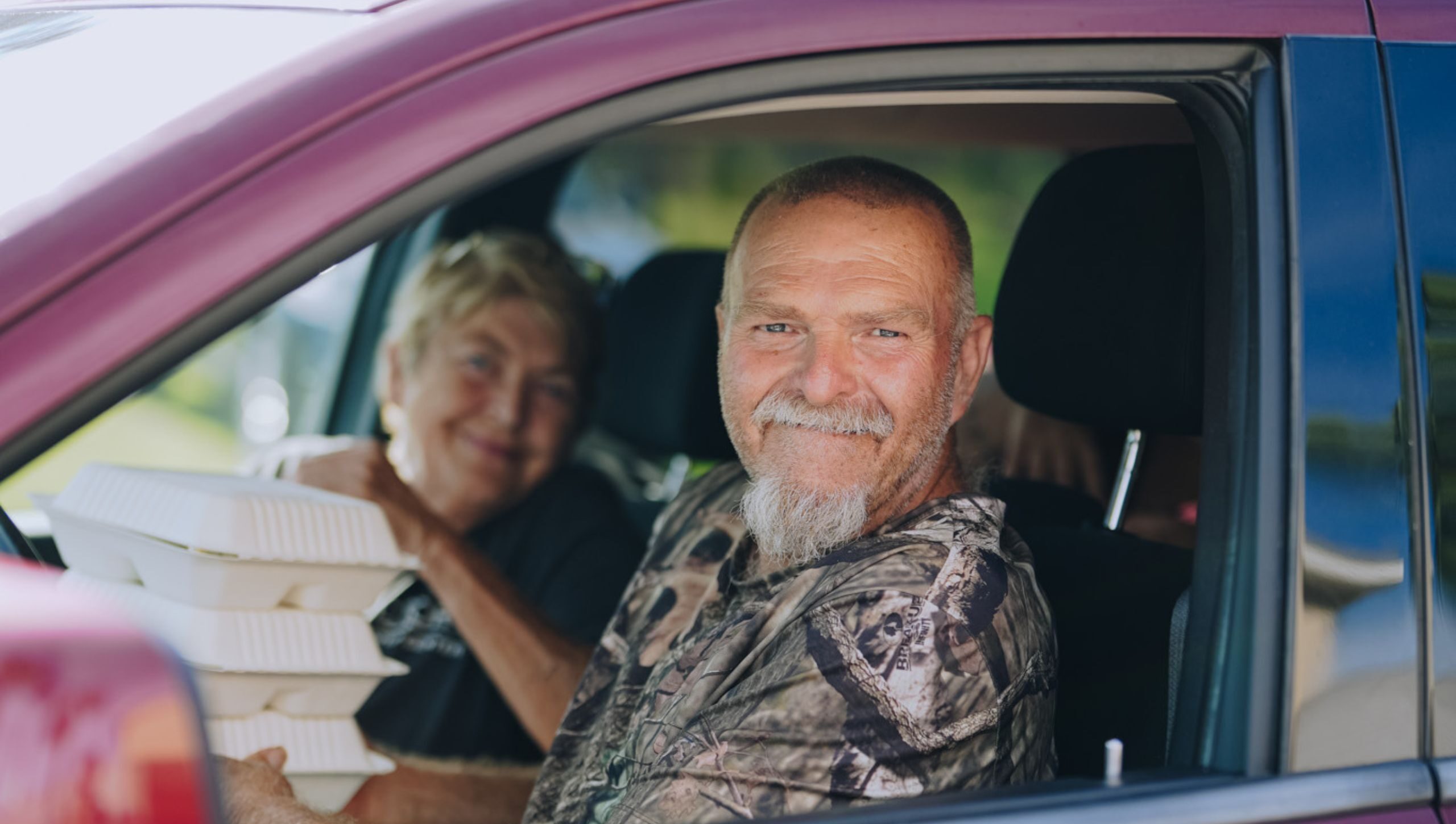 A couple receives a warm meal from Mercy Chefs in the aftermath of Hurricane Helene.
