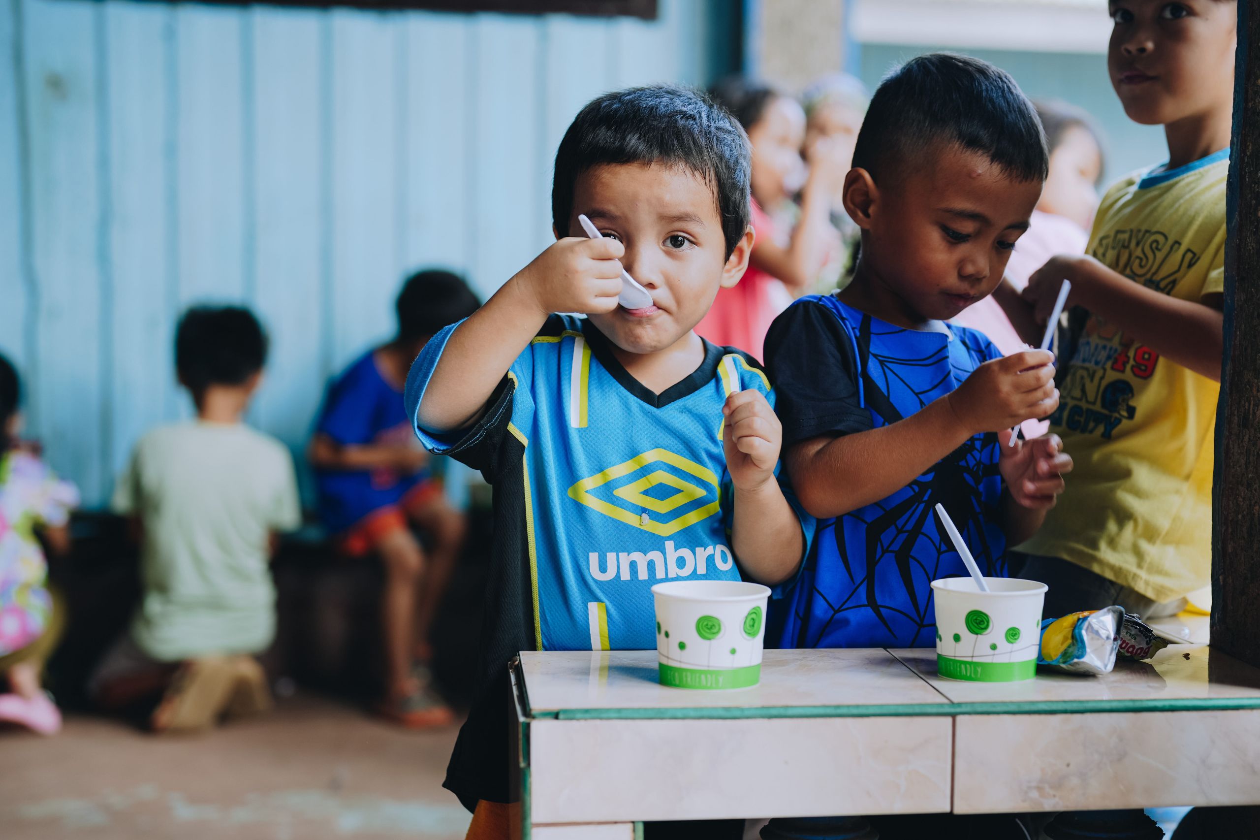 Children eating a hot meal in the Philippines