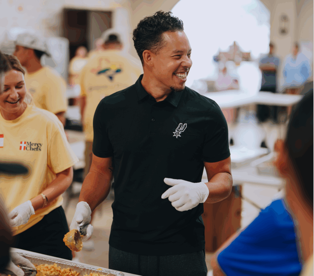 Spurs Head Coach Mitch Johnson helping prepare meals for Texas flood victims.