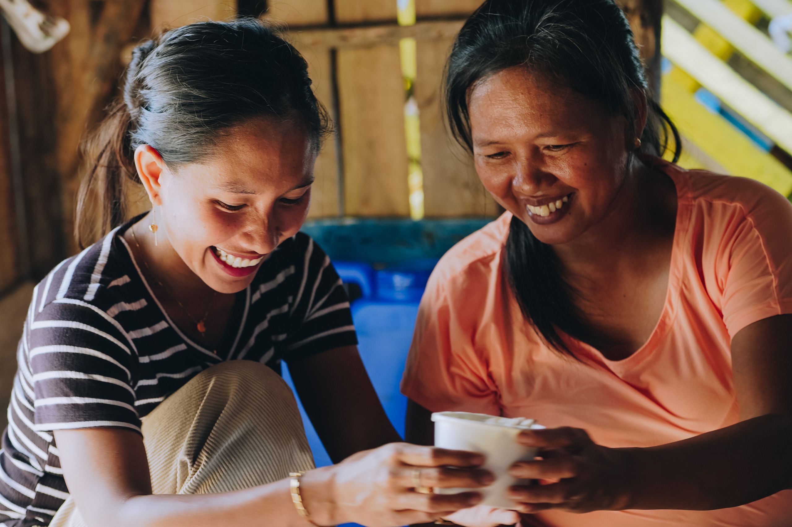 Two women serve meals in the Philippines