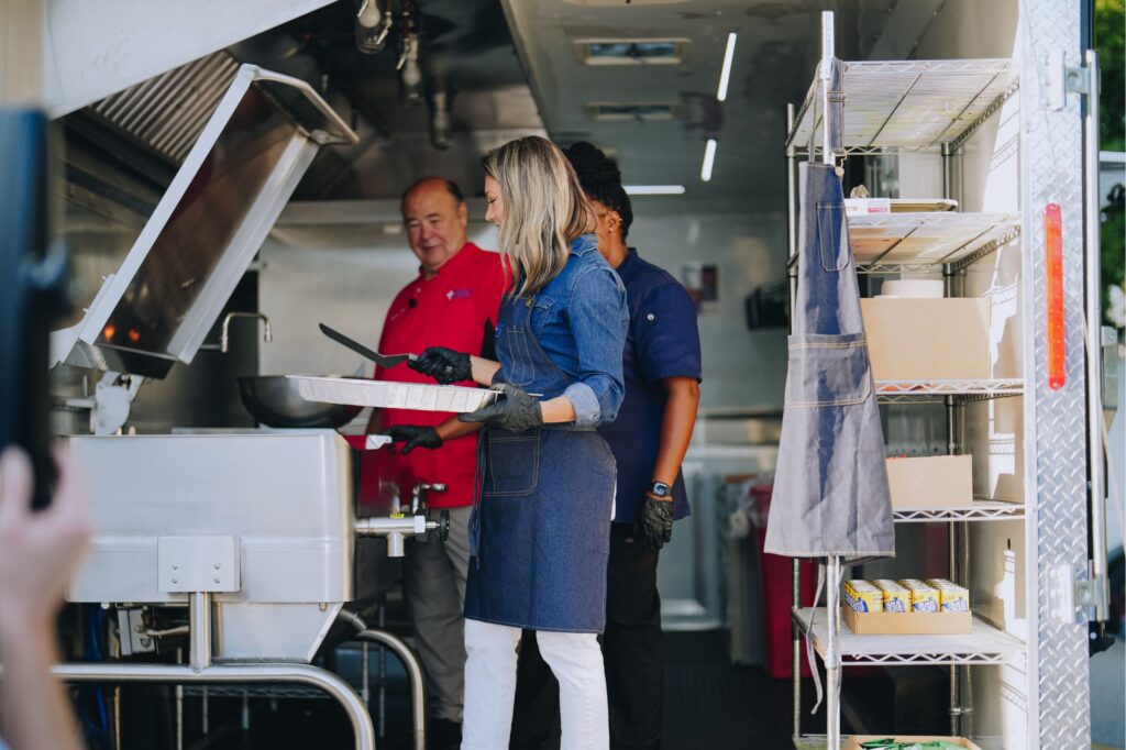 GMA meteorologist Ginger Zee cooks with Chef Gary and Chef Christina in a mobile kitchen