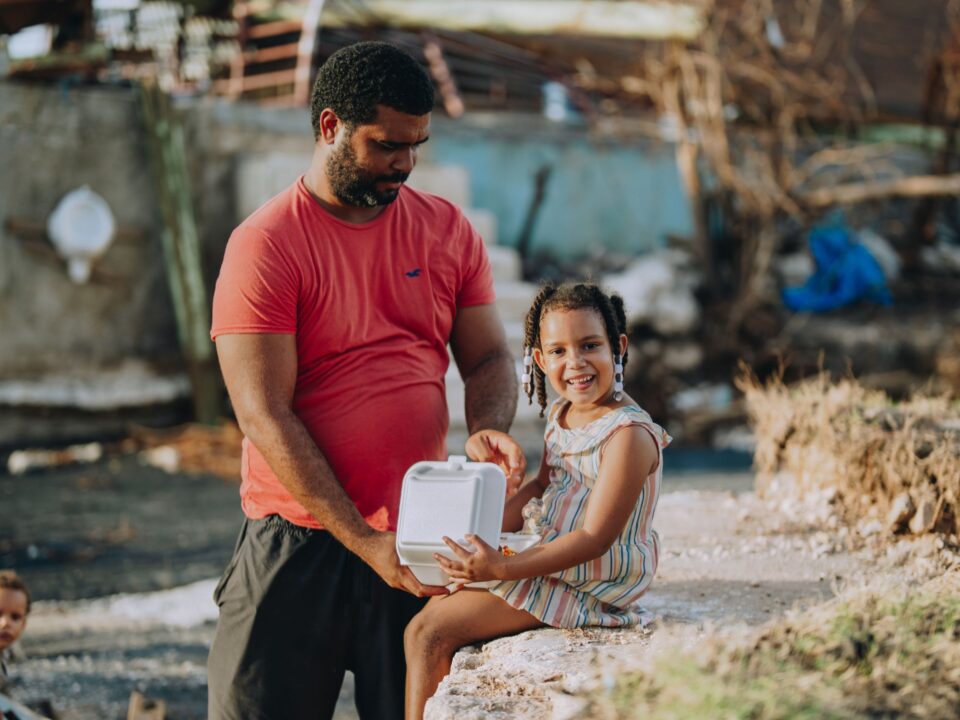A father and daughter receive a Mercy Chefs hot meal in Jamaica