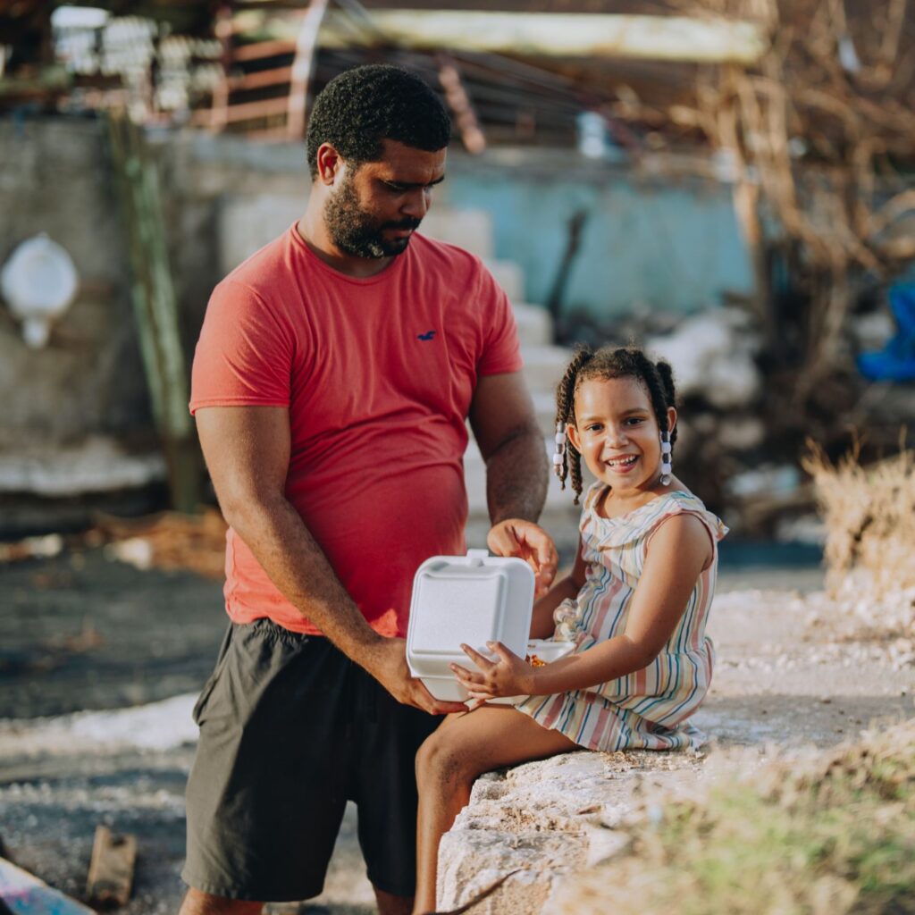 A father and daughter receive a Mercy Chefs hot meal in Jamaica