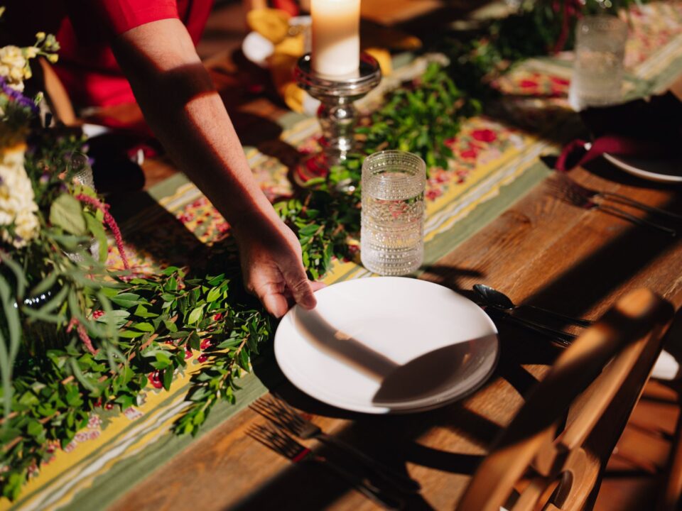 A hand setting the table