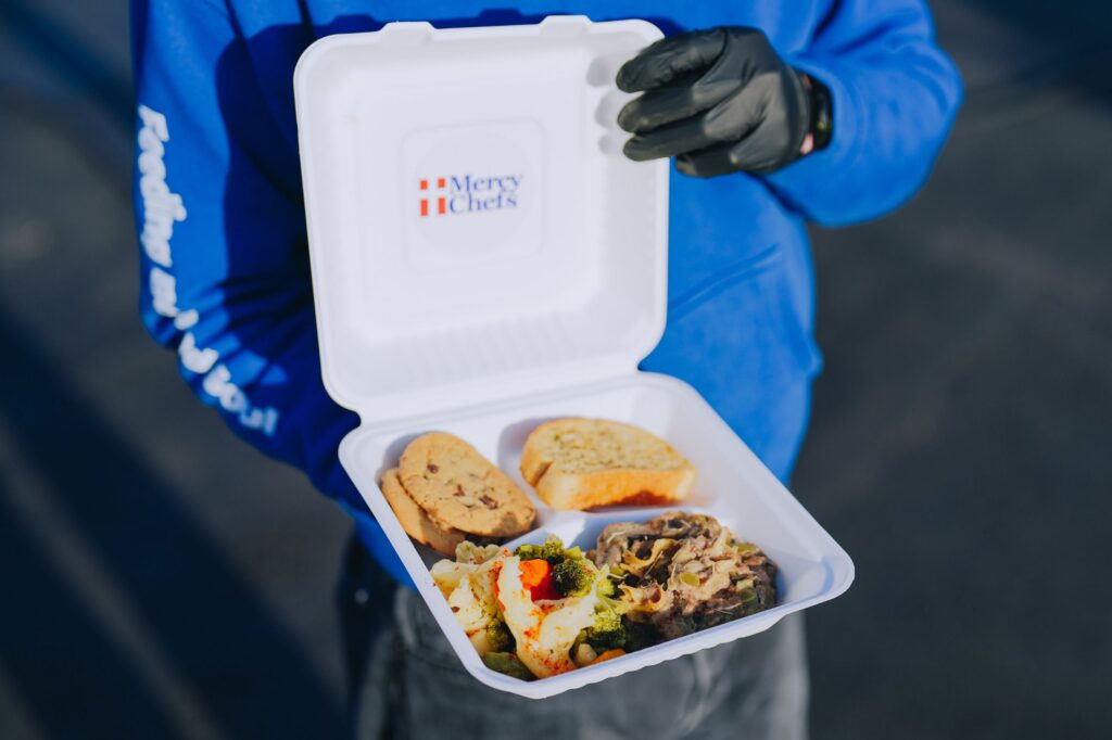A warm plate of granny's stroganoff, Cajun vegetables, garlic bread, and cookies, prepared by Mercy Chefs