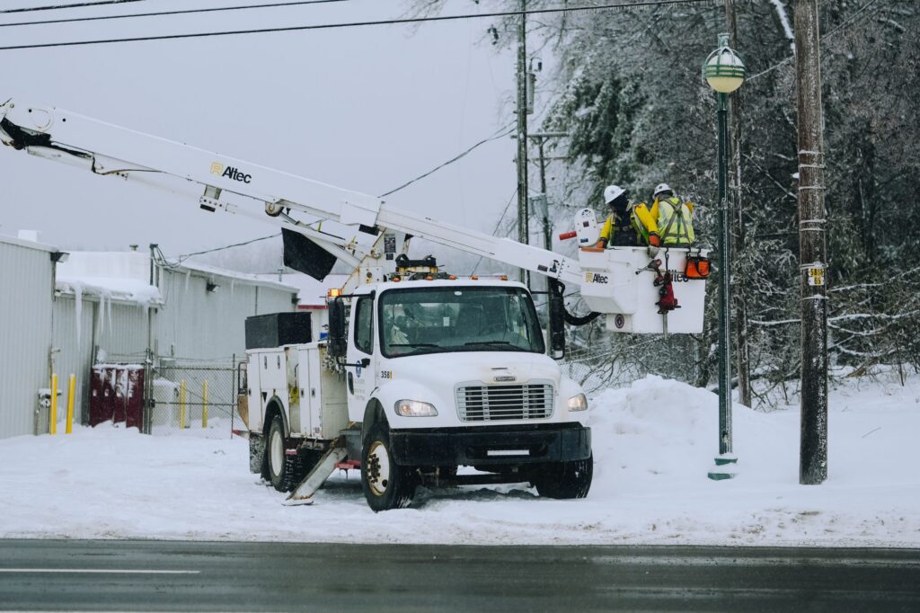 An emergency crew works to restore power lines in snowy Michigan