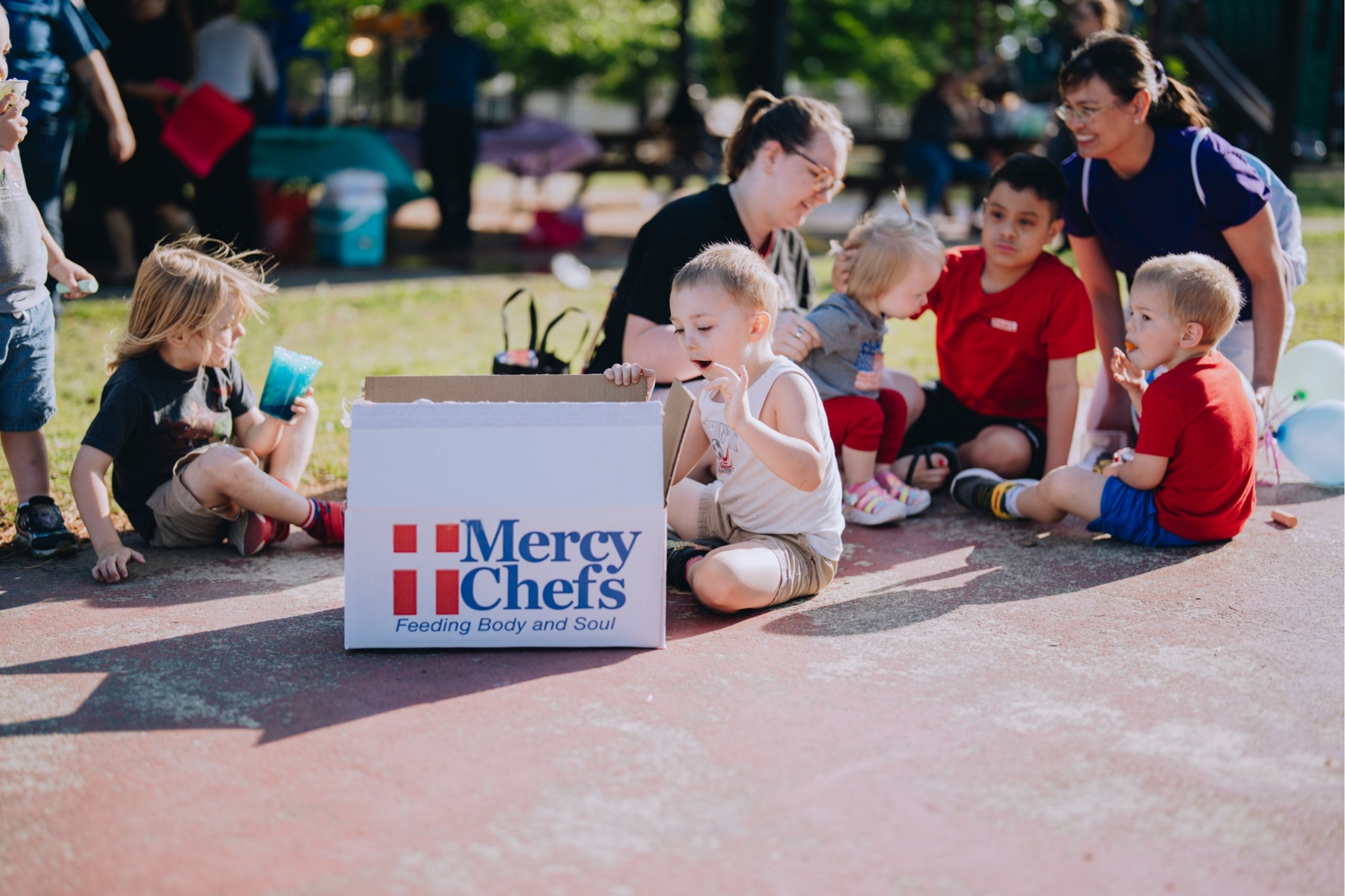 A child shows excitement upon opening a Family Grocery Box at Naval Station Norfolk