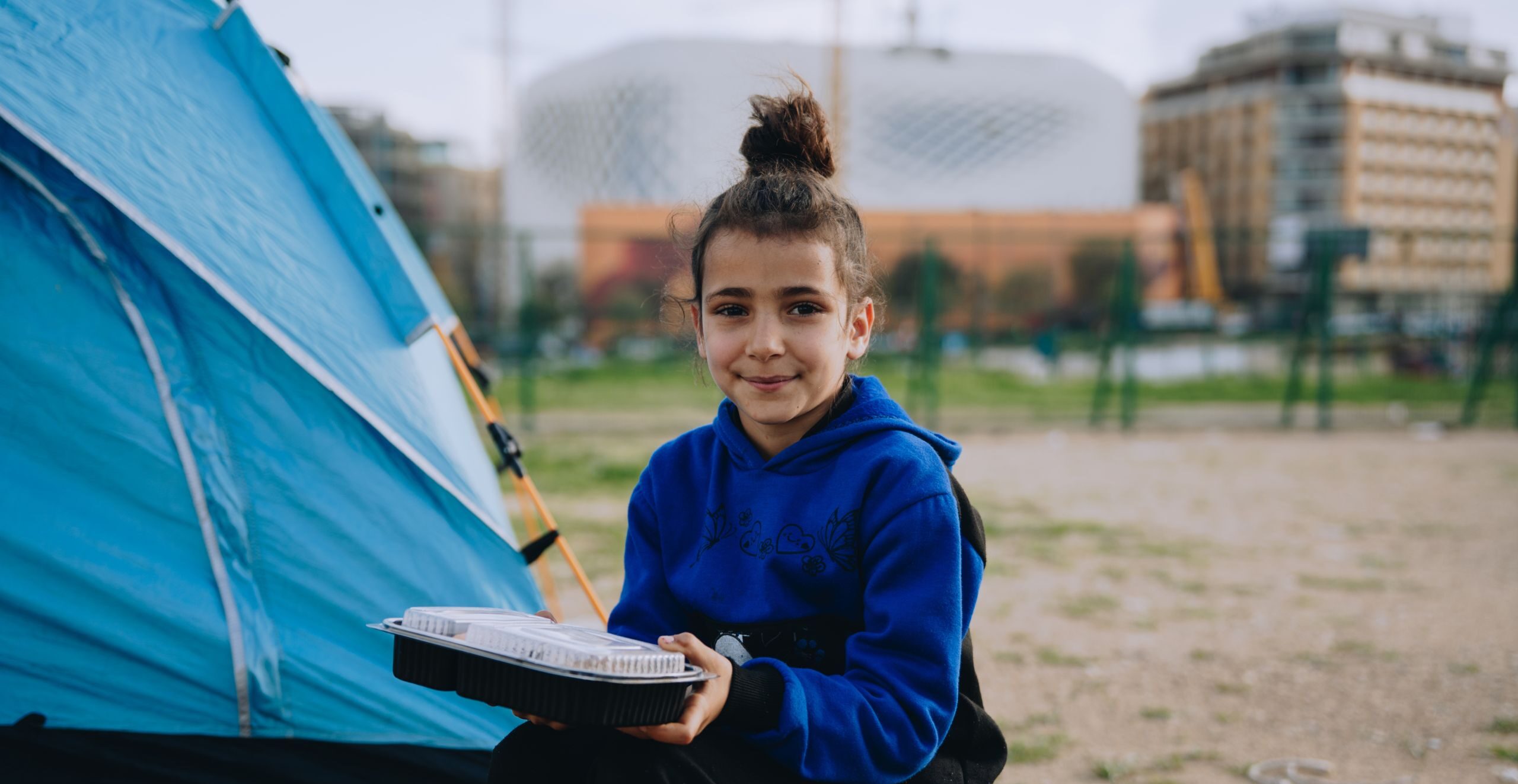 A young girl receives a Mercy Chefs meals in Beirut, Lebanon