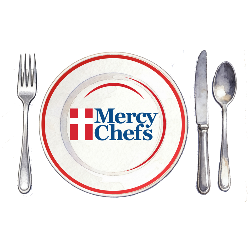 A hot plate of pork loin with Mac and cheese, green beans, and apple compote, prepared by Mercy Chefs