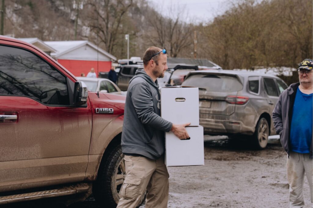 A volunteer carrying Family Grocery Boxes in West Virginia