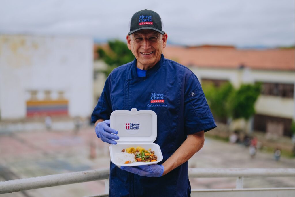 Chef Jaime holds a hot meal in Venezuela